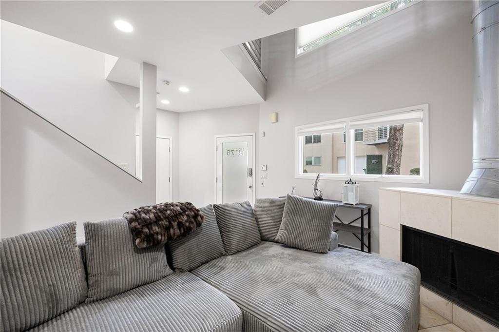 2176 Millennium Way Atlanta, GA 30319 - Photo 4 of 16 a living room with furniture a fireplace and a large window