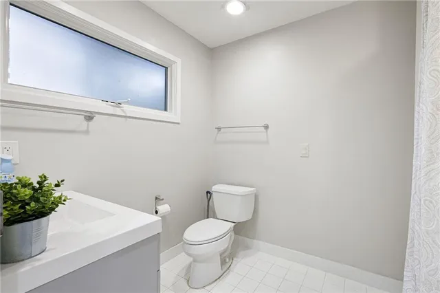a white toilet sitting next to a white sink
