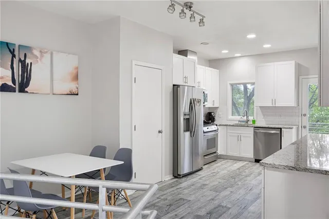 a kitchen with a refrigerator and a sink