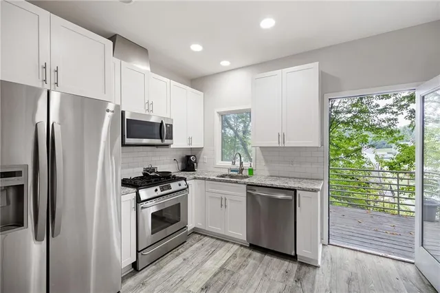 a kitchen with a stove a sink and a microwave