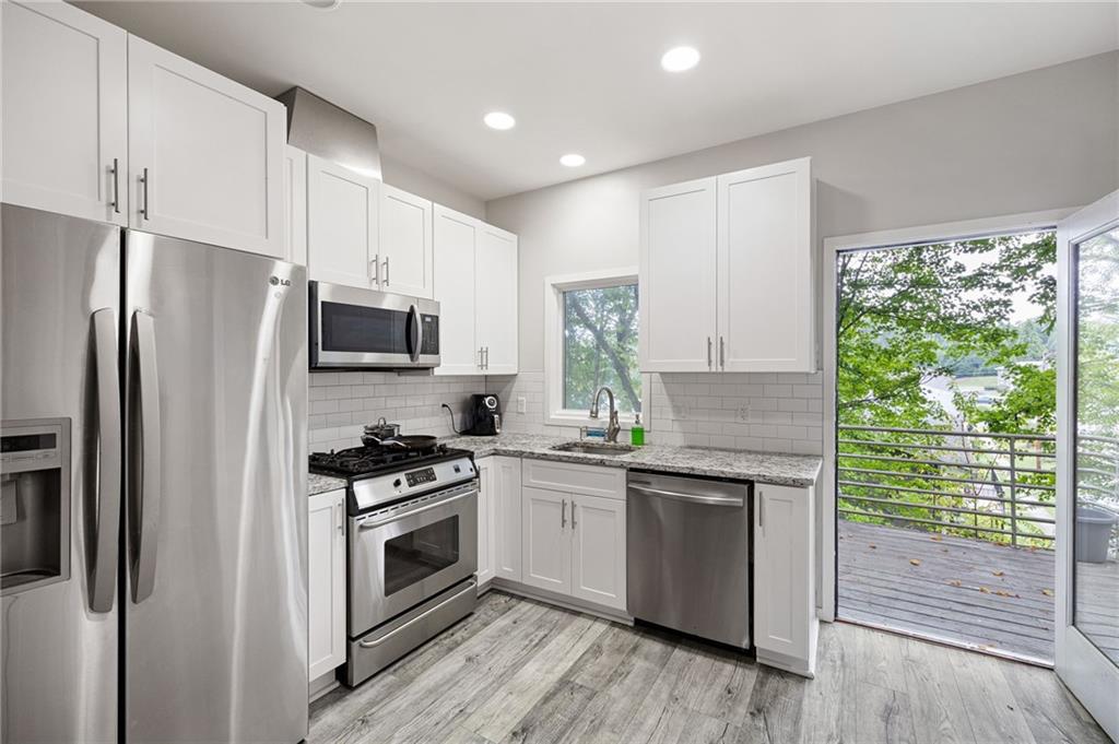 2176 Millennium Way Atlanta, GA 30319 - Photo 8 of 16 a kitchen with a stove a sink and a microwave
