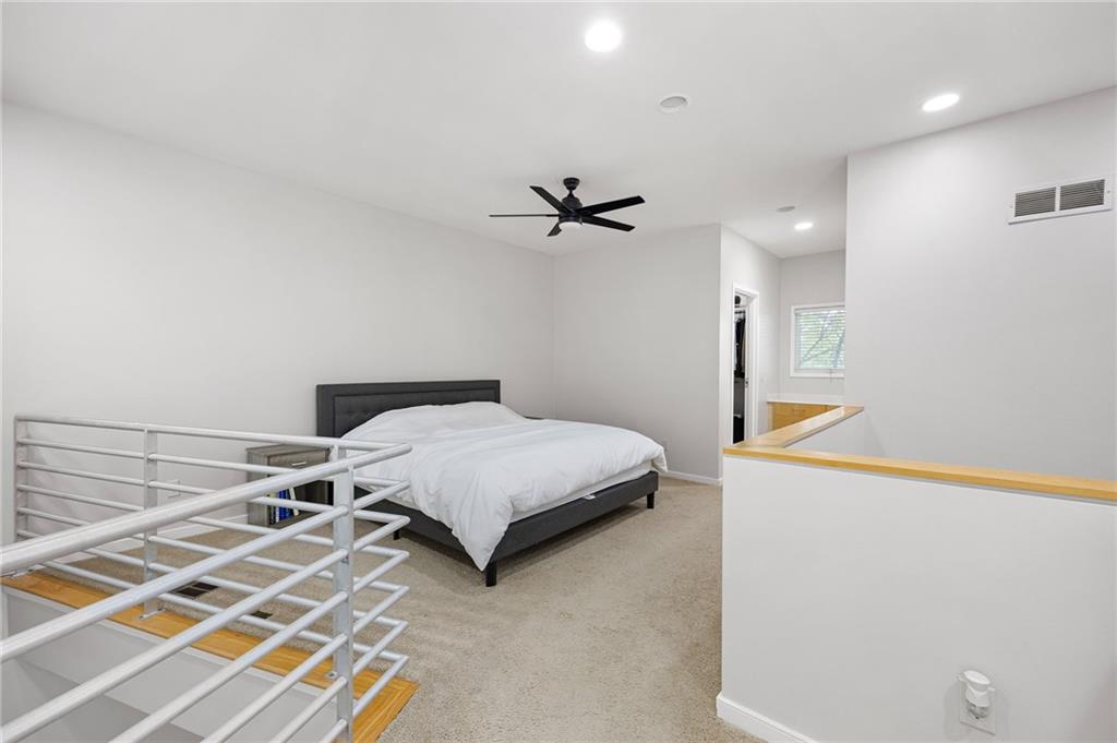 2176 Millennium Way Atlanta, GA 30319 - Photo 10 of 16 a bedroom with a bed and a ceiling fan