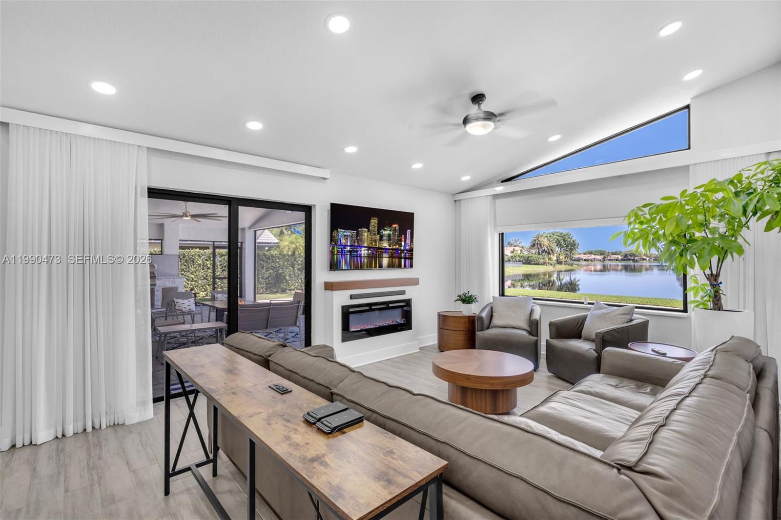 2920 Old Orchard Road Davie, FL 33328 - Photo 13 of 62 a living room with furniture a flat screen tv and a large window