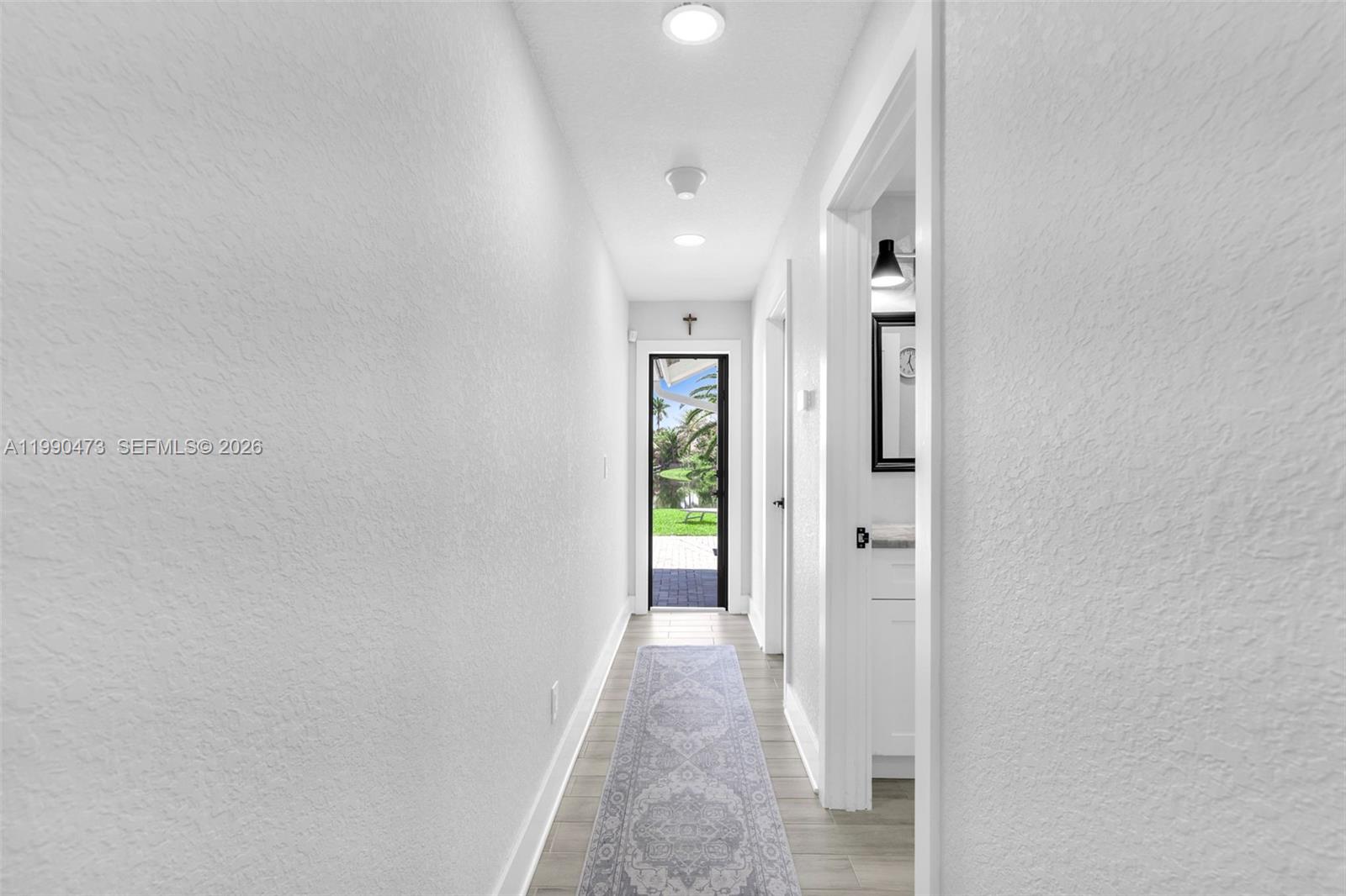 2920 Old Orchard Road Davie, FL 33328 - Photo 18 of 62 a view of a hallway with wooden floor and a bathroom