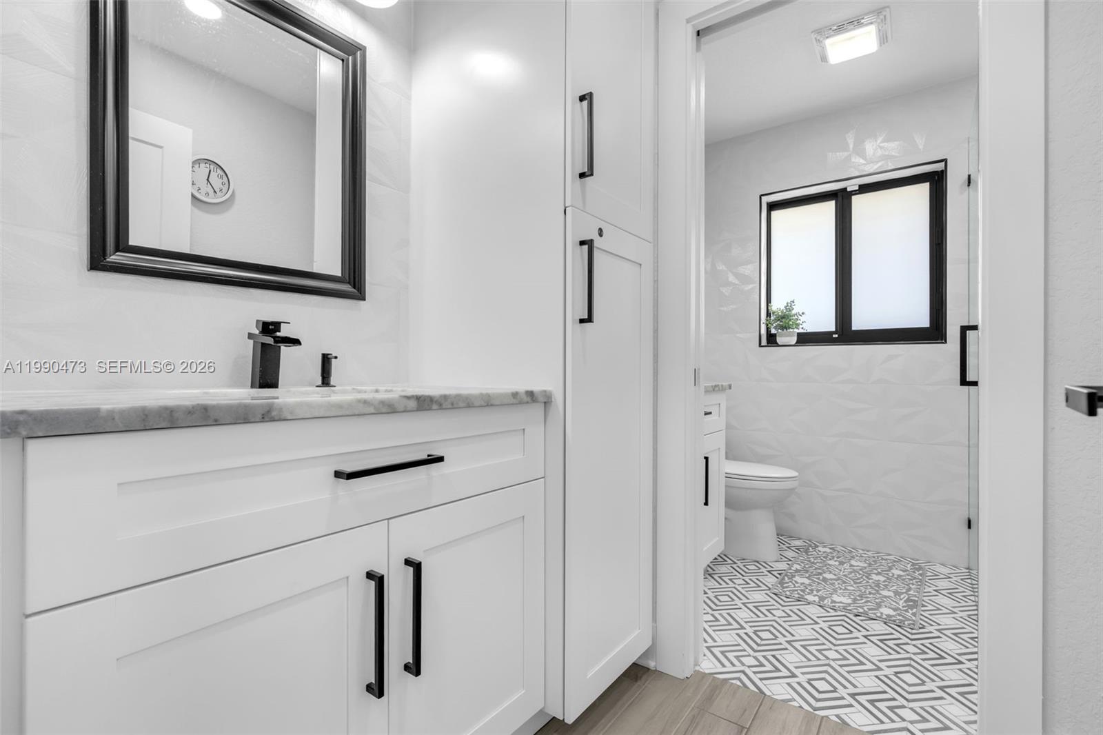2920 Old Orchard Road Davie, FL 33328 - Photo 19 of 62 a bathroom with a toilet sink and mirror