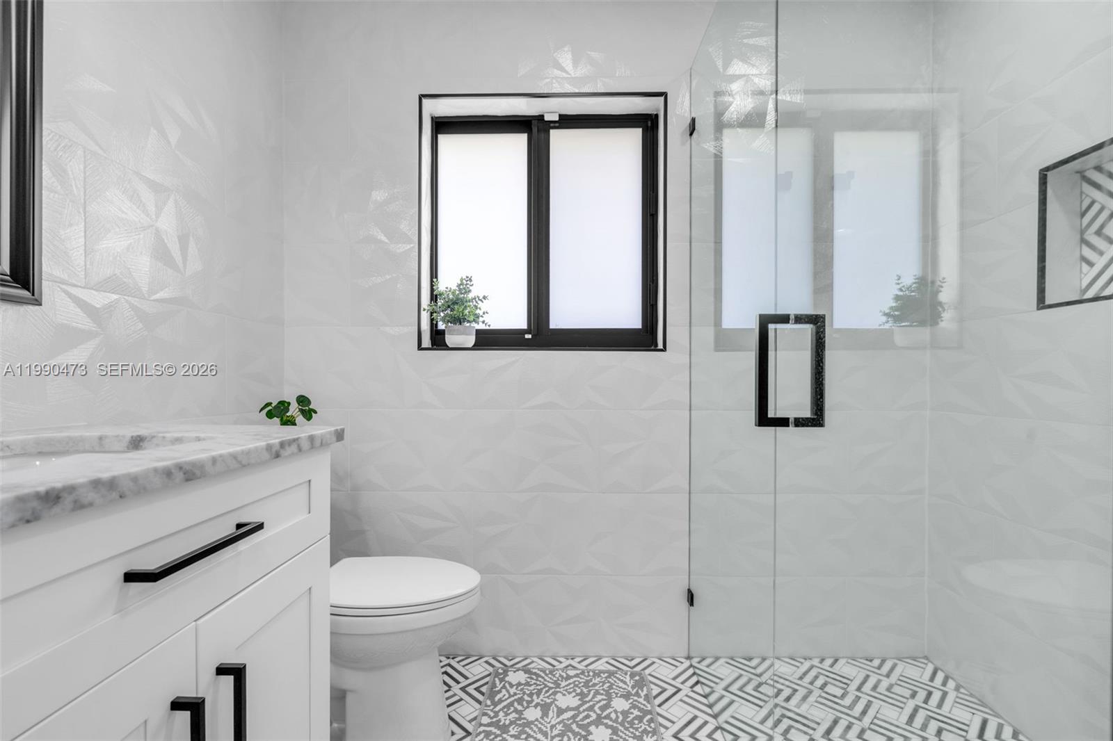 2920 Old Orchard Road Davie, FL 33328 - Photo 20 of 62 a bathroom with a granite countertop toilet sink and mirror
