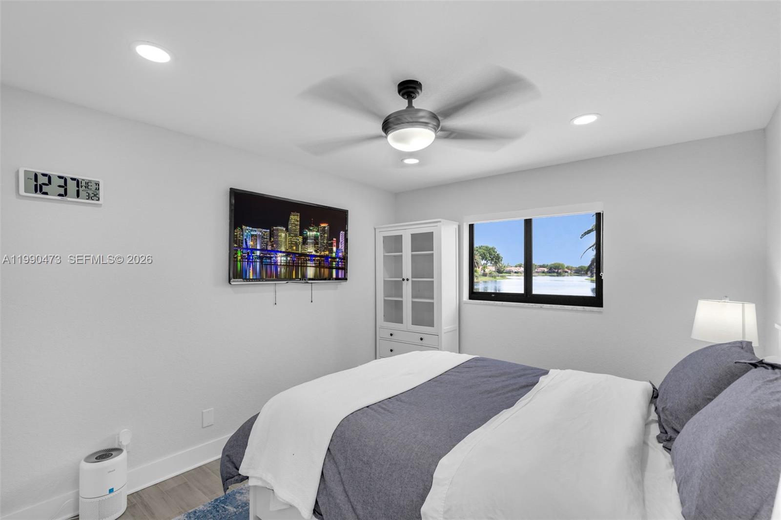 2920 Old Orchard Road Davie, FL 33328 - Photo 22 of 62 a bedroom with a large bed and a chandelier