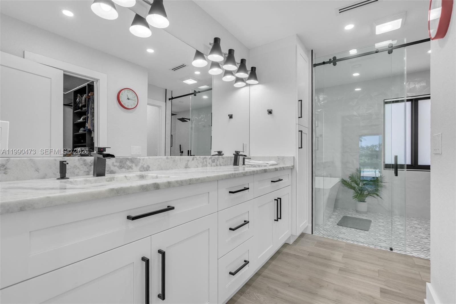 2920 Old Orchard Road Davie, FL 33328 - Photo 27 of 62 a bathroom with a granite countertop sink a large mirror and a shower