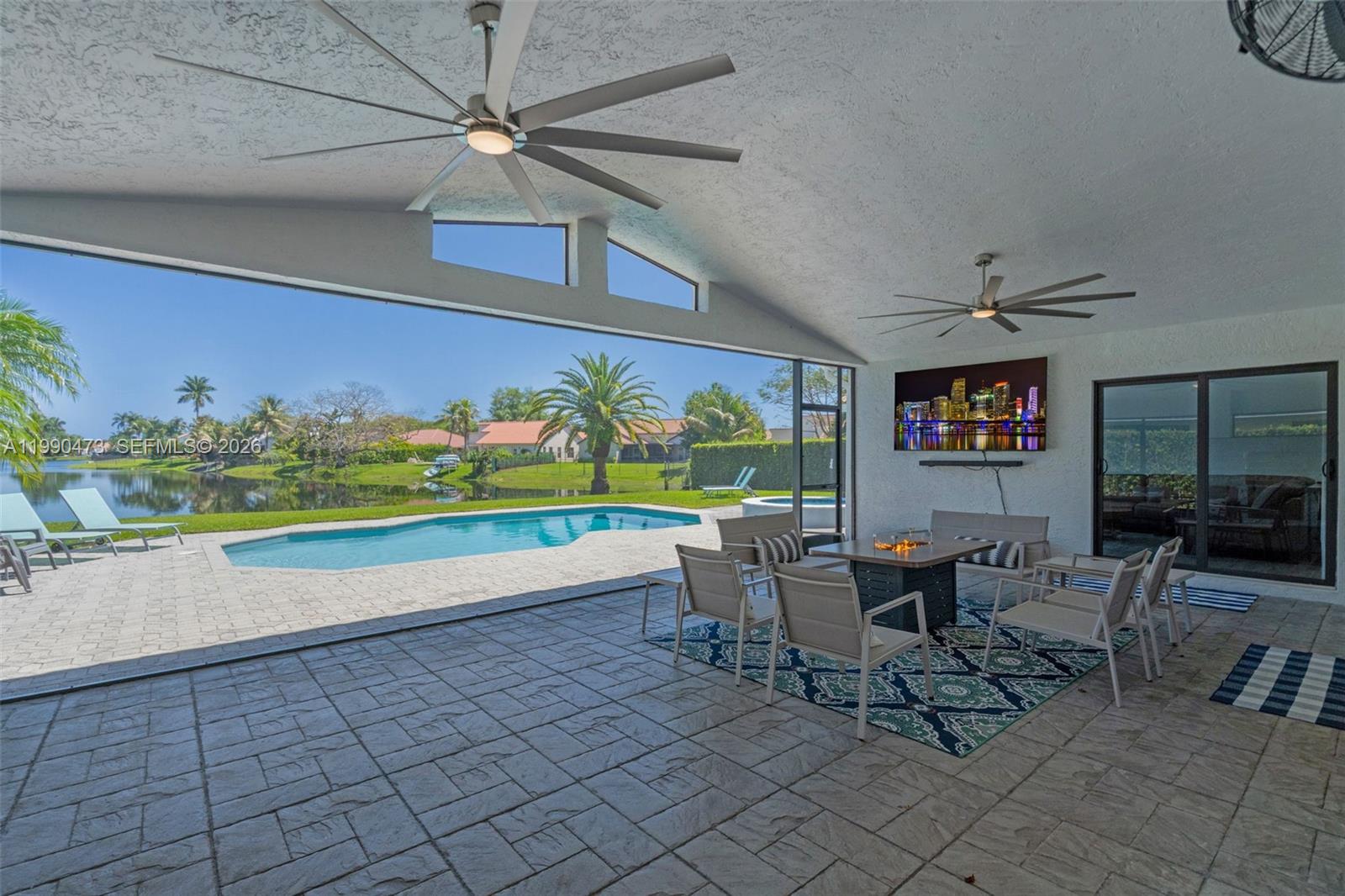 2920 Old Orchard Road Davie, FL 33328 - Photo 36 of 62 a view of a dining room with furniture a rug and a floor to ceiling window