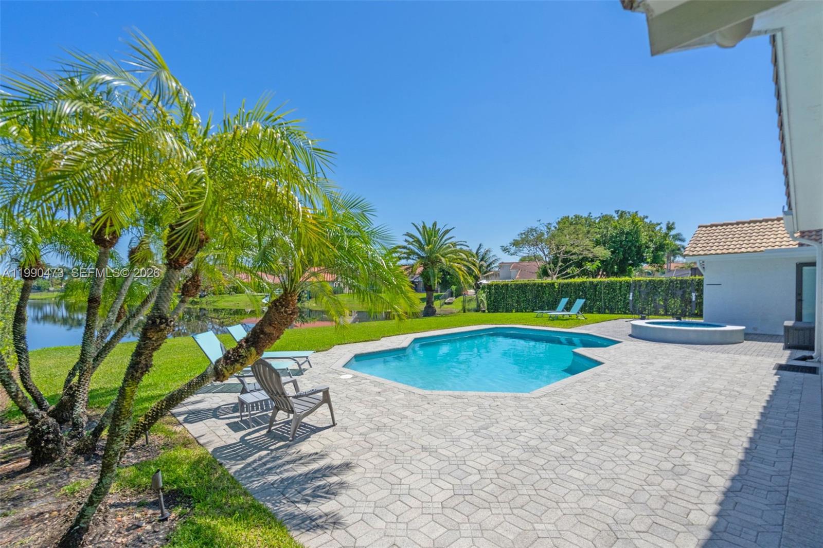 2920 Old Orchard Road Davie, FL 33328 - Photo 37 of 62 a view of a swimming pool with a yard and sitting area