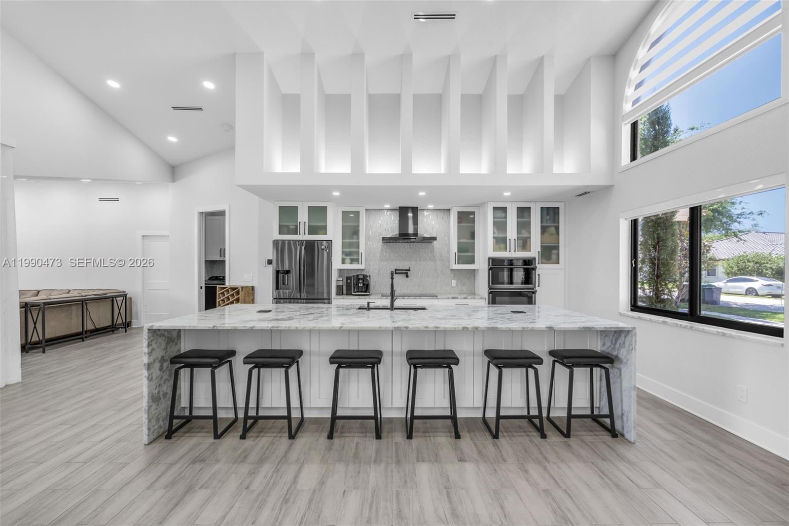 2920 Old Orchard Road Davie, FL 33328 - Photo 7 of 62 a large white kitchen with a table and chairs in it