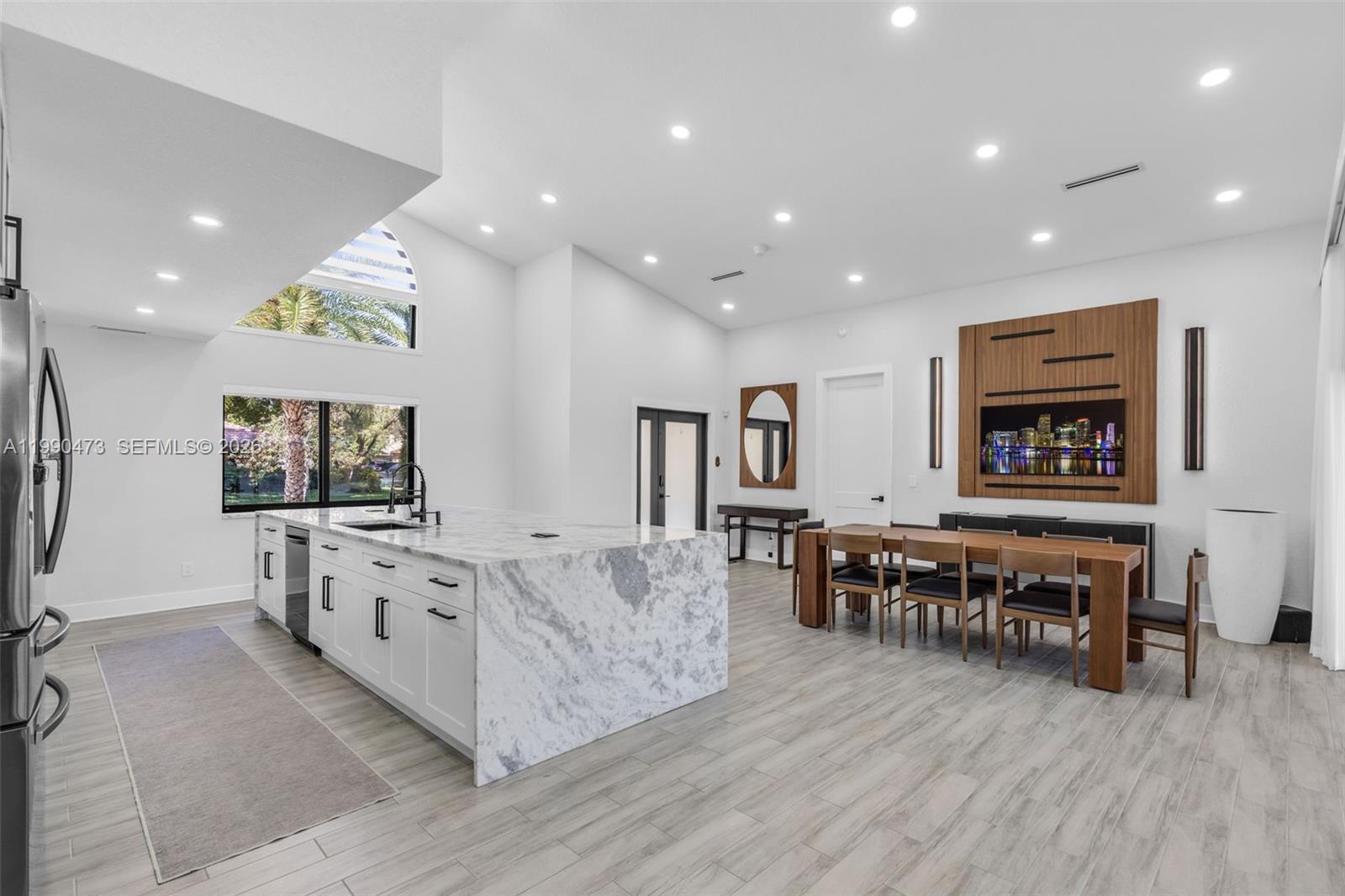 2920 Old Orchard Road Davie, FL 33328 - Photo 10 of 62 a large living room with stainless steel appliances granite countertop a couch and a dining table