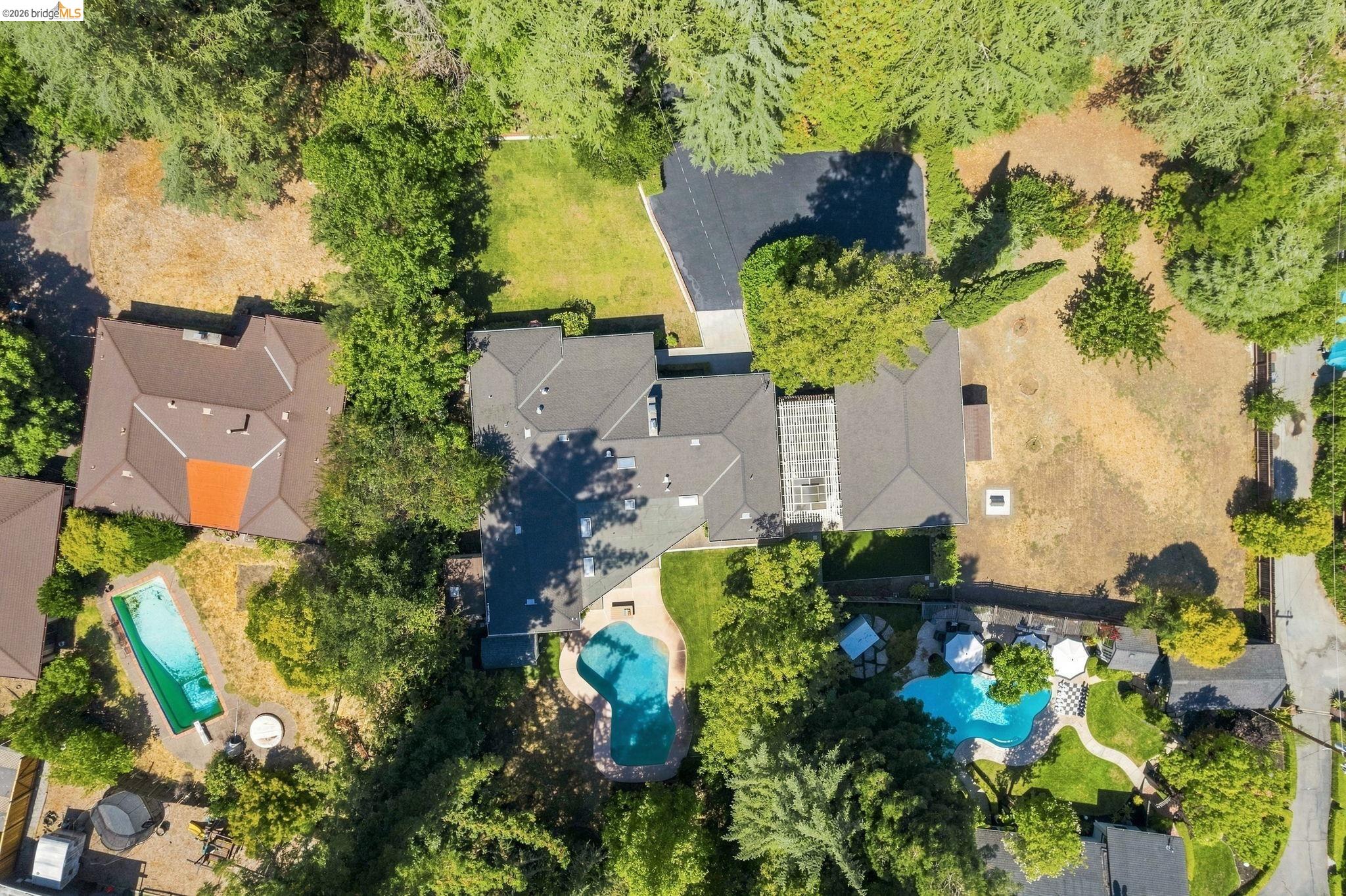 5075 Alhambra Valley Road Martinez, CA 94553 - Photo 62 of 68 Property featuring multiple structures, a curvilinear swimming pool, and mature trees