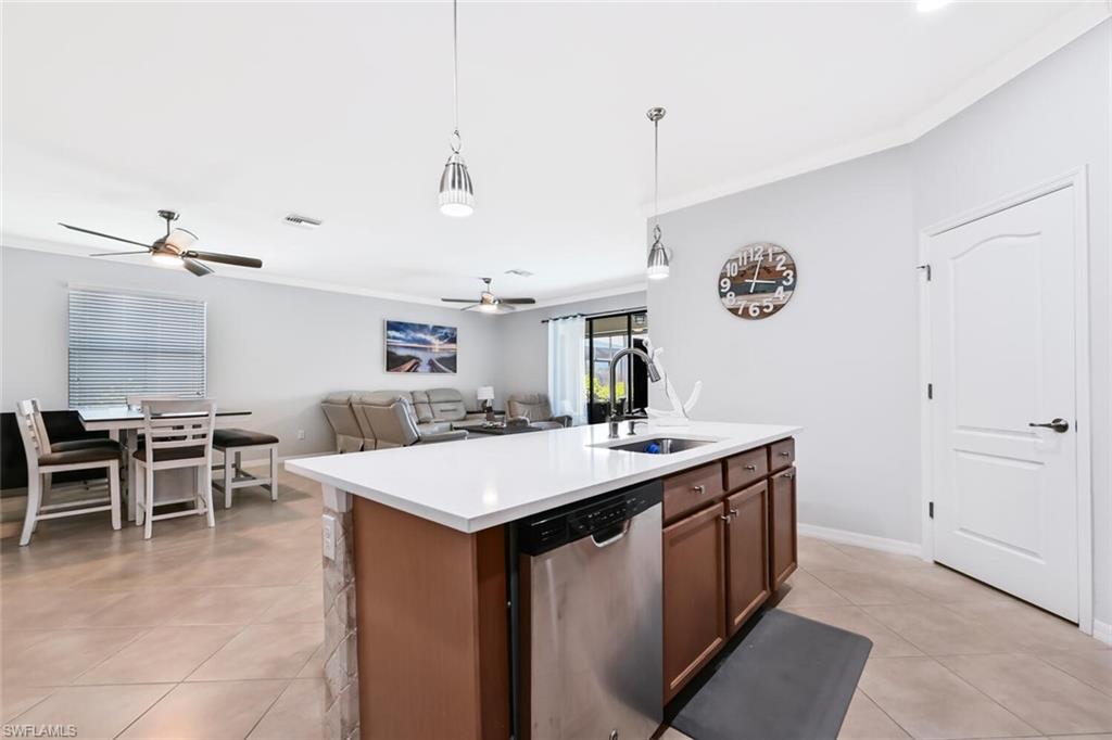 3742 Treasure Cove Circle Naples, FL 34114 - Photo 11 of 22 a large kitchen with a table and chairs