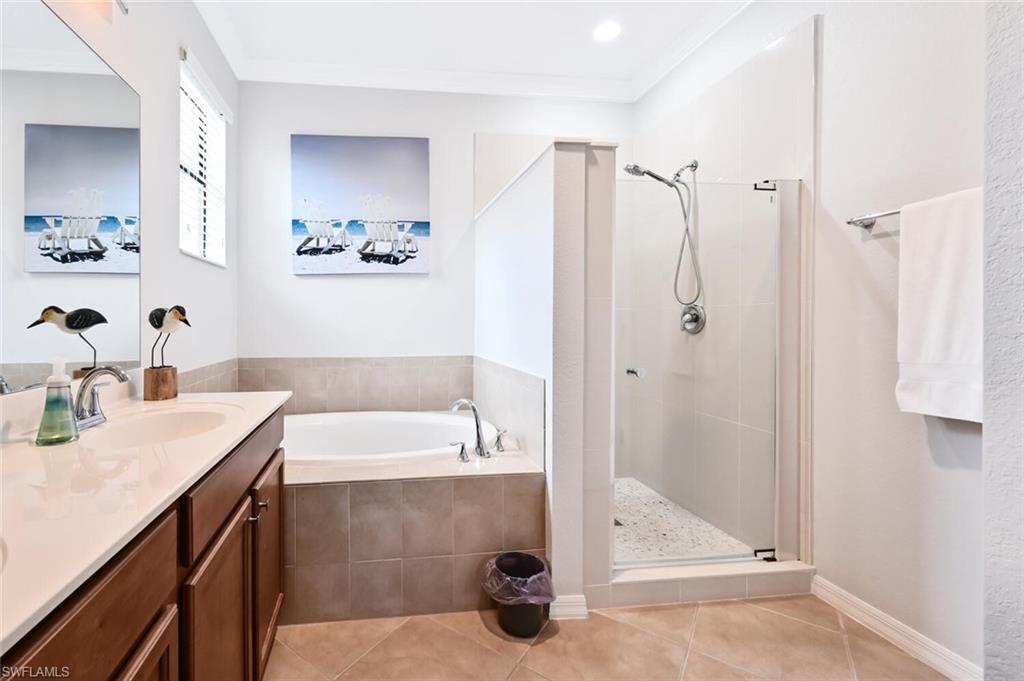 3742 Treasure Cove Circle Naples, FL 34114 - Photo 15 of 22 a bathroom with a tub sink and mirror