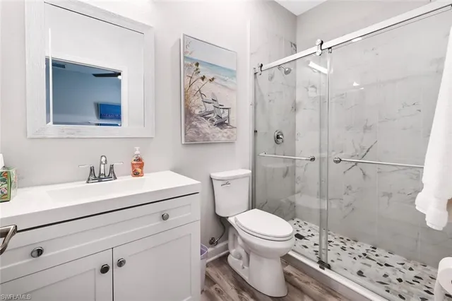 a bathroom with a sink toilet and shower