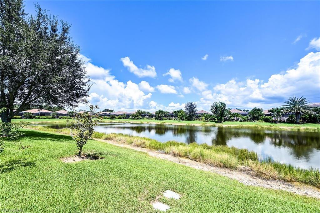 3742 Treasure Cove Circle Naples, FL 34114 - Photo 22 of 22 a view of a lake with houses in the back