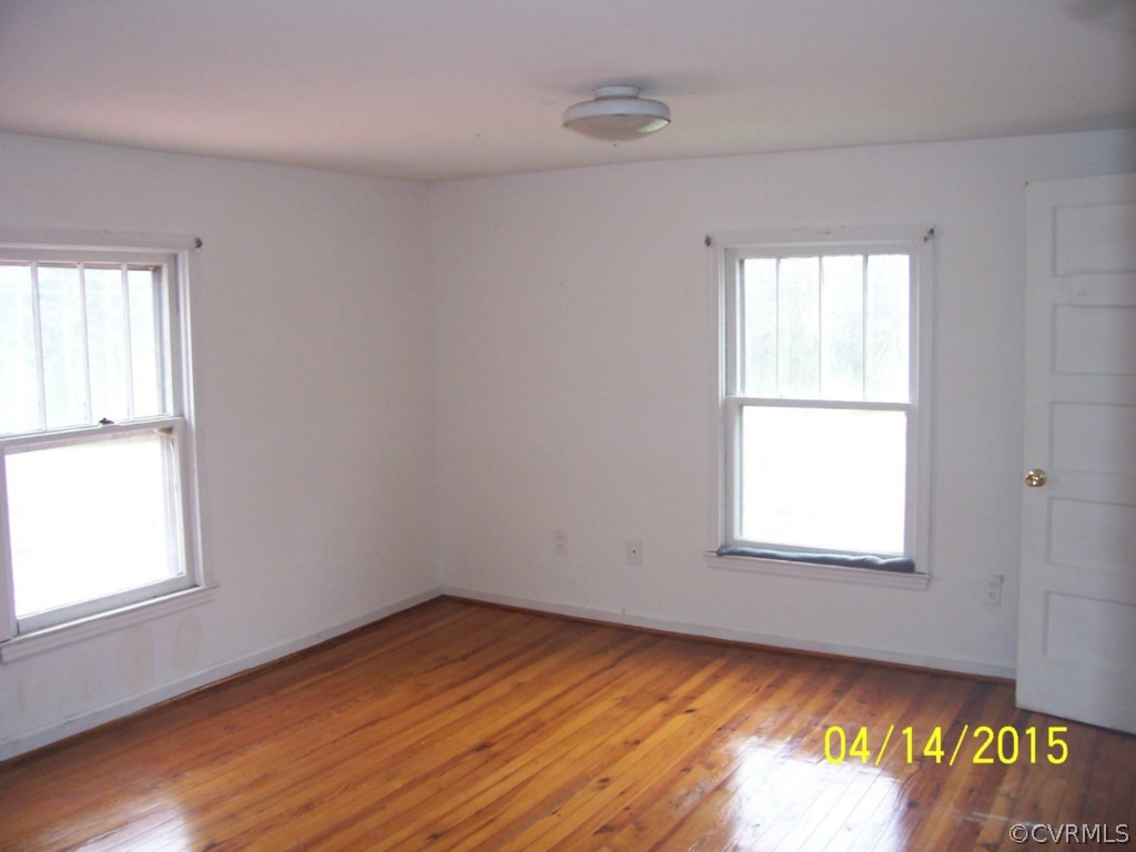25118 Carson Road Carson, VA 23830 - Photo 6 of 8 an empty room with wooden floor and windows
