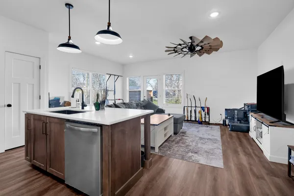 a kitchen with stainless steel appliances a sink stove and cabinets