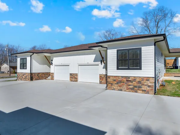 a front view of a house with large parking space