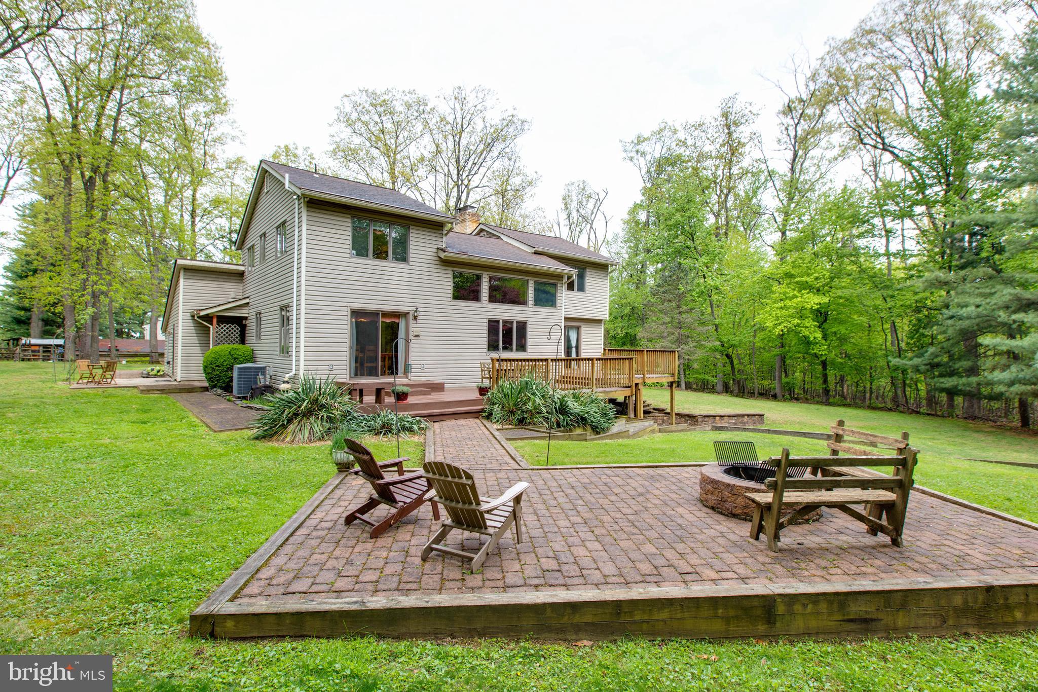 5519 Woodbine Road Sykesville, MD 21784 - Photo 67 of 69 a view of a house with backyard sitting area and garden
