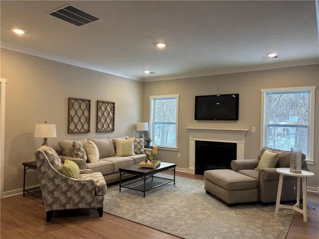 a living room with furniture flat screen tv and a fireplace