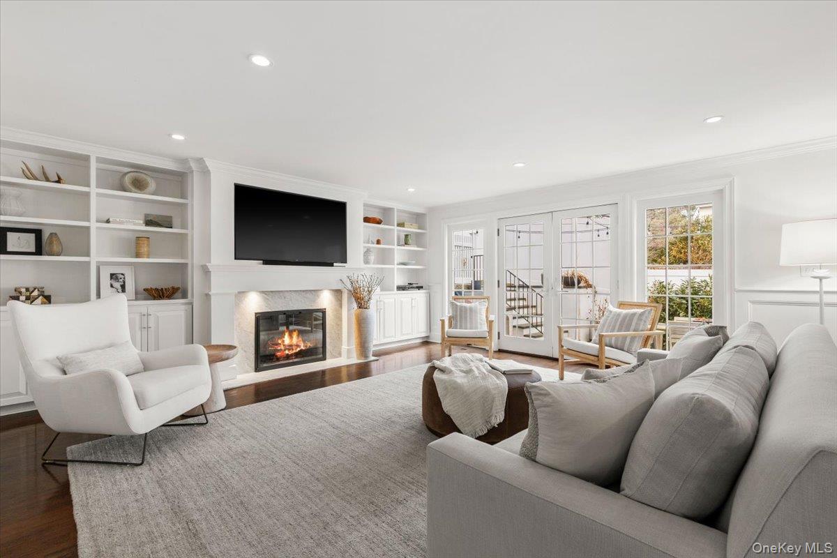 2 Cowles Avenue Rye, NY 10580 - Photo 16 of 35 a living room with furniture a fireplace and a flat screen tv