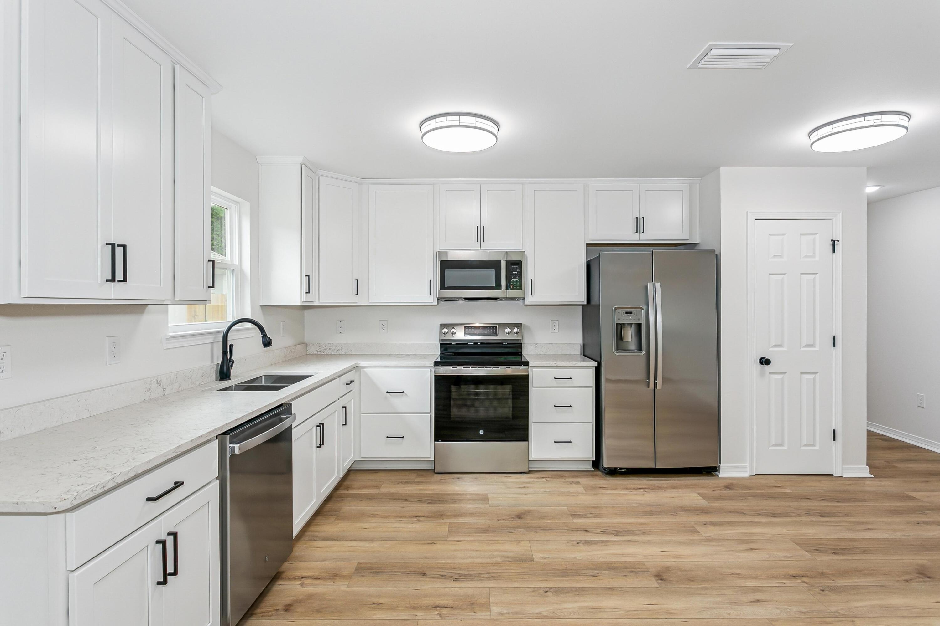 8086 3rd Street Laurel Hill, FL 32567 - Photo 12 of 35 a kitchen with a sink cabinets and stainless steel appliances