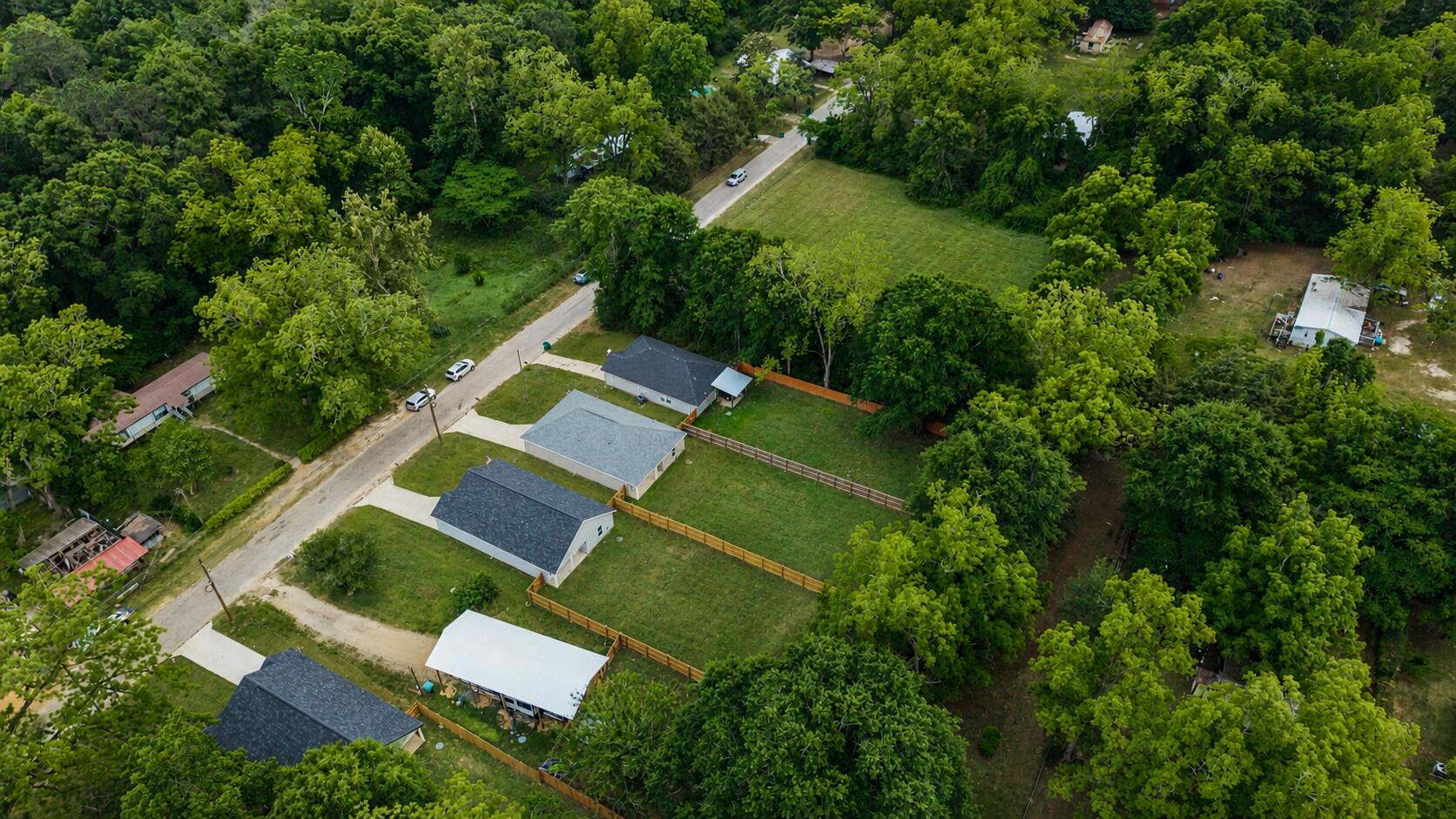 8086 3rd Street Laurel Hill, FL 32567 - Photo 3 of 35 an aerial view of a house with outdoor space and trees all around