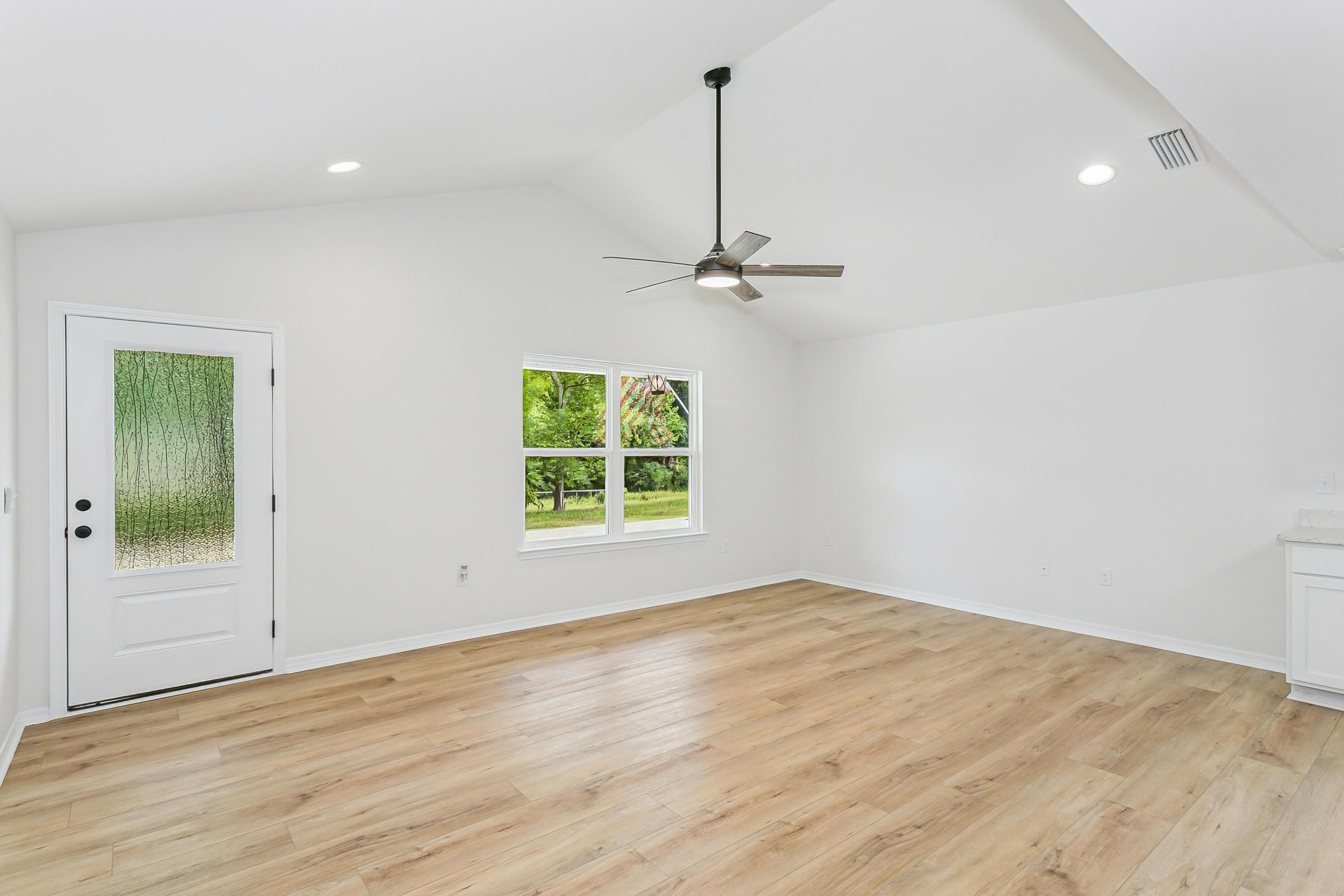 8086 3rd Street Laurel Hill, FL 32567 - Photo 7 of 35 a view of a room with a window and wooden floor