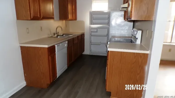 a kitchen with stainless steel appliances a refrigerator and a stove