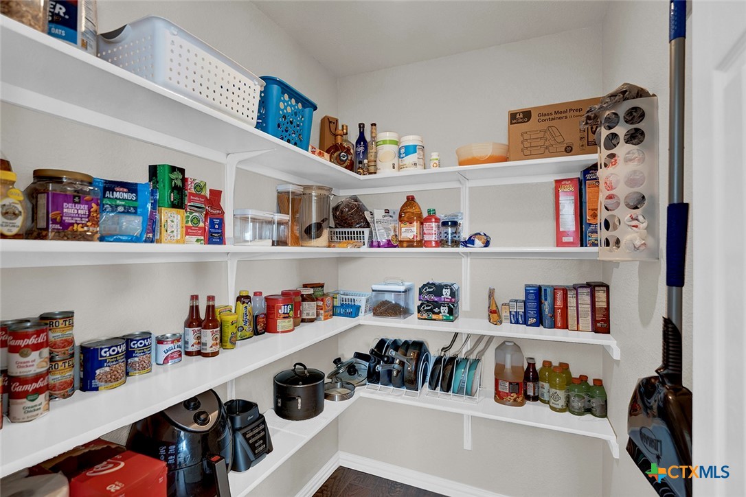 113 Endeavour Kyle, TX 78640 - Photo 15 of 38 a room with a refrigerator and a shelf