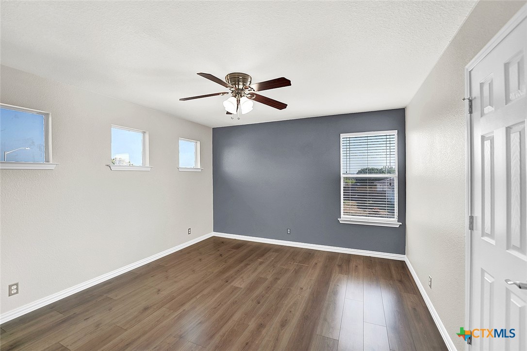 113 Endeavour Kyle, TX 78640 - Photo 26 of 38 a view of an empty room with a window and wooden floor