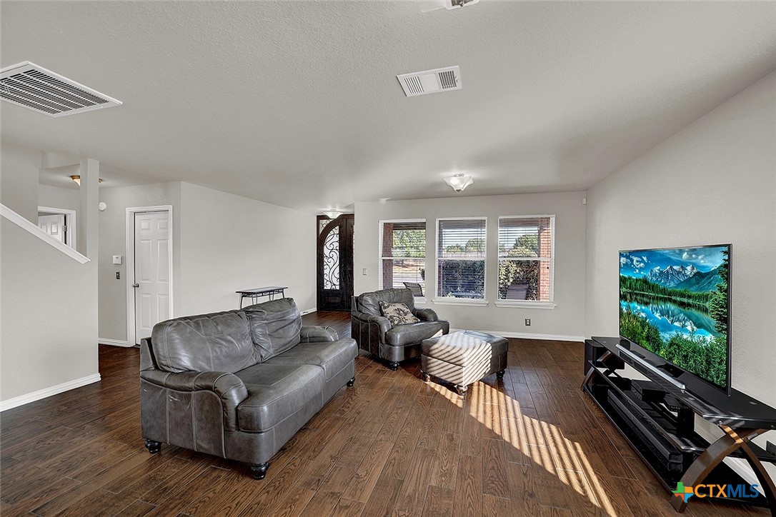 113 Endeavour Kyle, TX 78640 - Photo 7 of 38 a living room with furniture flat screen tv and a large window