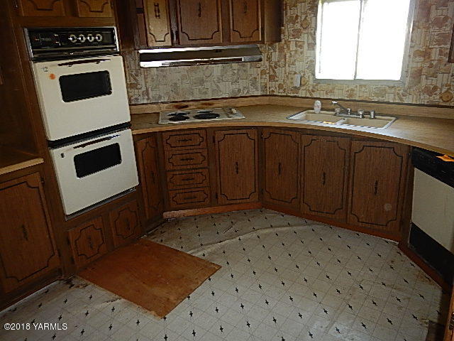 10331 Larue Road Toppenish, WA 98948 - Photo 5 of 13 a kitchen with a sink stove and cabinets