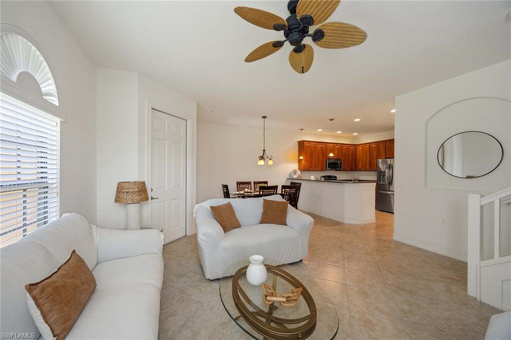 9134 Chula Vista Street, Unit 125 Naples, FL 34113 - Photo 11 of 44 a living room with furniture and kitchen view