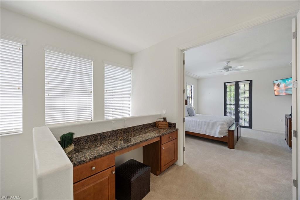 9134 Chula Vista Street, Unit 125 Naples, FL 34113 - Photo 12 of 44 a living room with furniture and a window