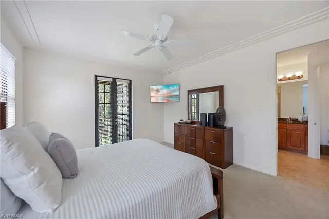 a bedroom with a bed and a large mirror