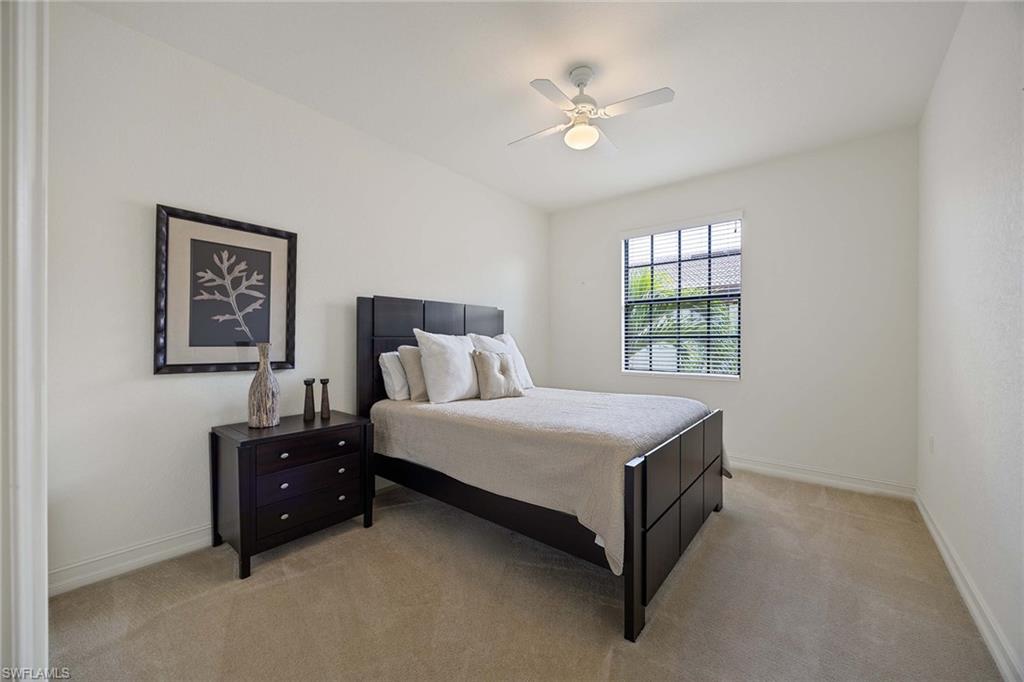 9134 Chula Vista Street, Unit 125 Naples, FL 34113 - Photo 19 of 44 a bedroom with a bed and window