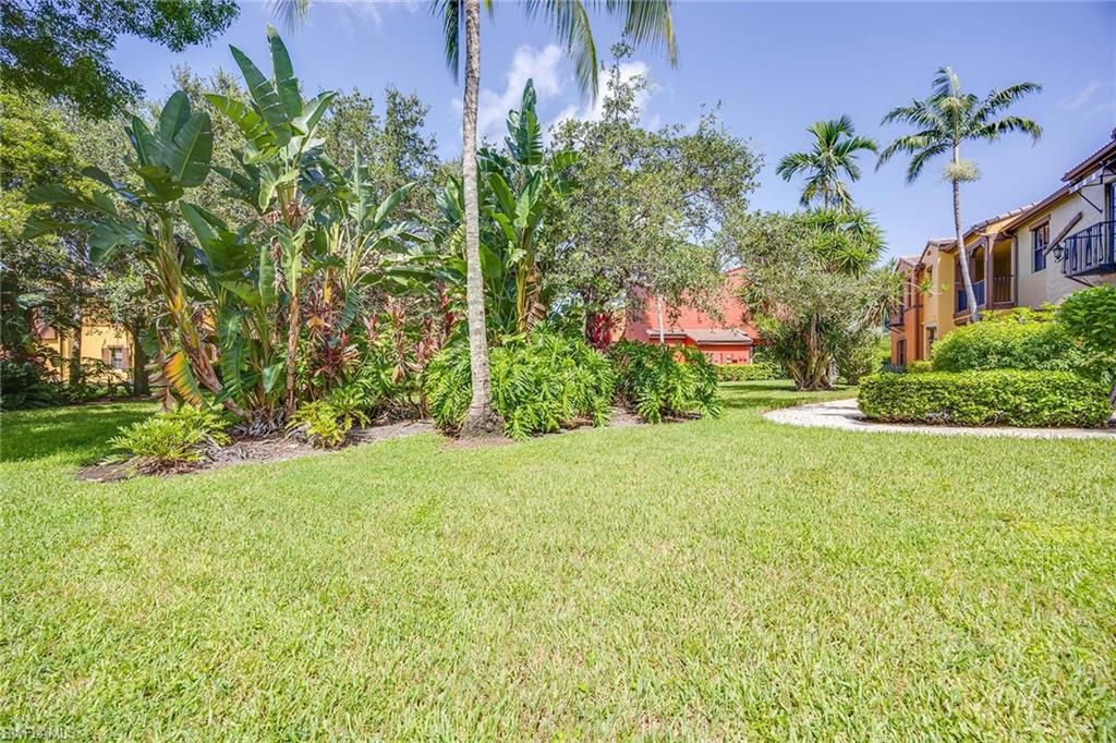 9134 Chula Vista Street, Unit 125 Naples, FL 34113 - Photo 22 of 44 a front view of a house with garden