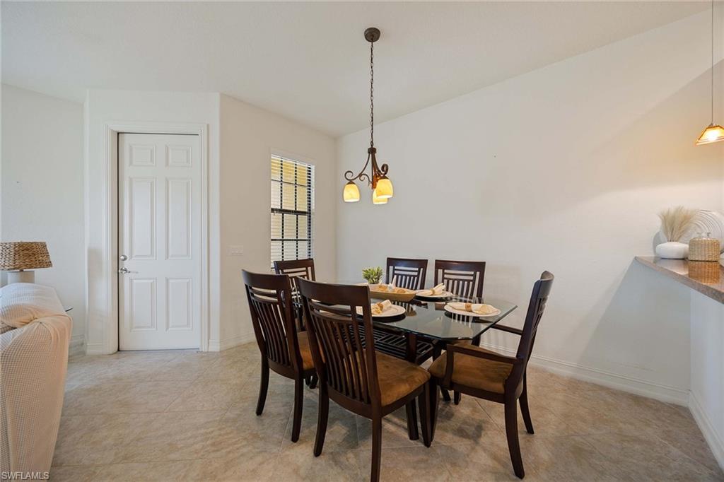 9134 Chula Vista Street, Unit 125 Naples, FL 34113 - Photo 4 of 44 a view of a dining room with furniture