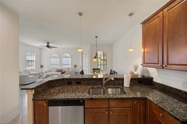 a kitchen with counter top space sink and cabinets