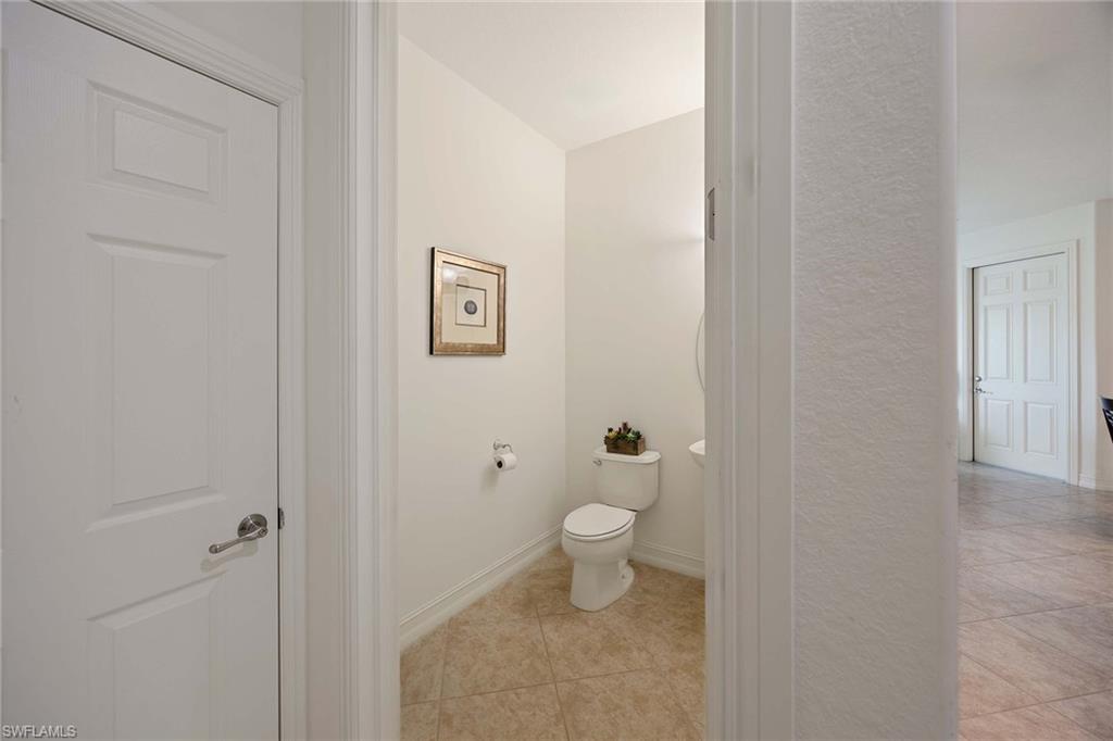 9134 Chula Vista Street, Unit 125 Naples, FL 34113 - Photo 8 of 44 a bathroom with a toilet and a shower