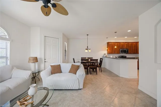 a living room with furniture and kitchen view