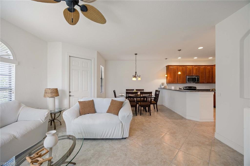 9134 Chula Vista Street, Unit 125 Naples, FL 34113 - Photo 10 of 44 a living room with furniture and kitchen view