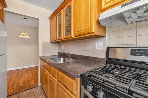 a kitchen with stainless steel appliances granite countertop a sink stove and cabinets