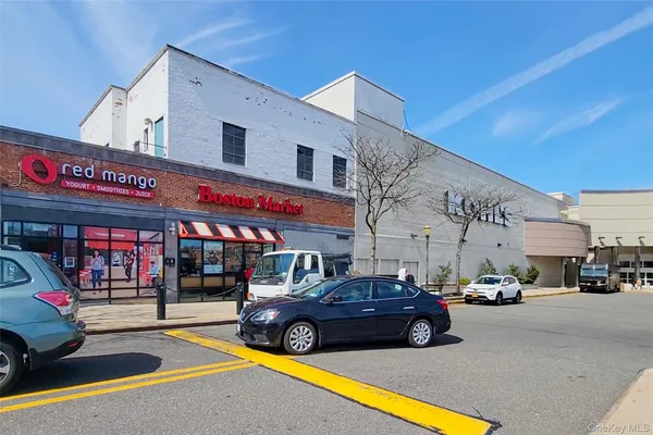 a view of a cars park in front of building