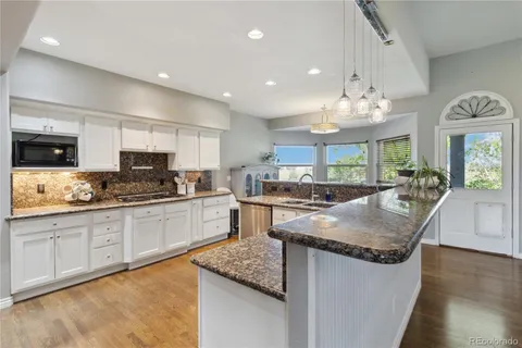a kitchen with granite countertop counter space a sink appliances and cabinets