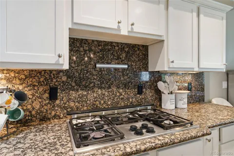 a stove top oven sitting inside of a kitchen