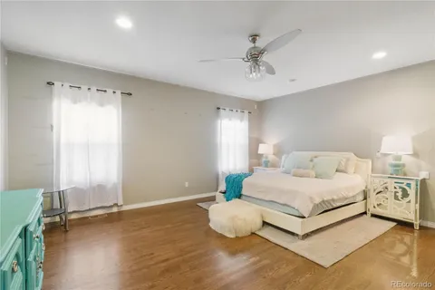 a spacious bedroom with a bed and a window